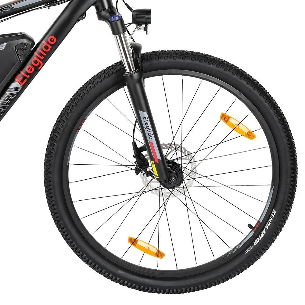 Eleglide M2 27.5" Electric Mountain Bike, 15.5MPH close up of the front wheel  in a white studio setting 